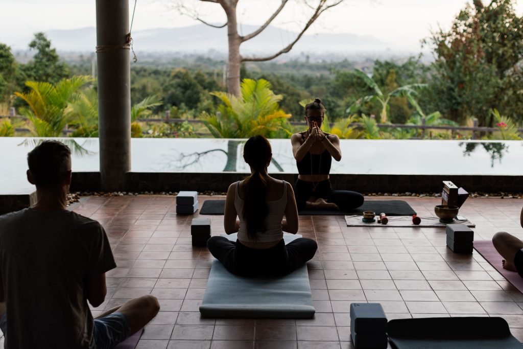 Sillhutte of people practising morning yoga at Amaya