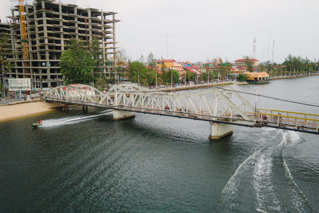 a top view of Kampot's river where a jetski and a boat can be seen 